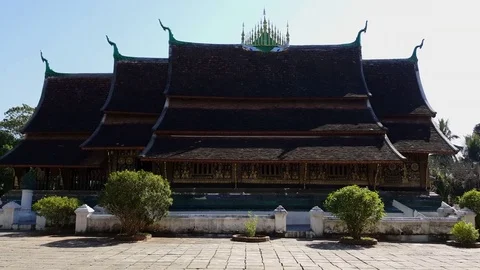Wat Xieng Thong temple side view on a sunny day, roof tops,  Luang Prabang Stockbeeldmateriaal 81738622