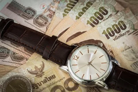 Watch and banknote Stock Photos