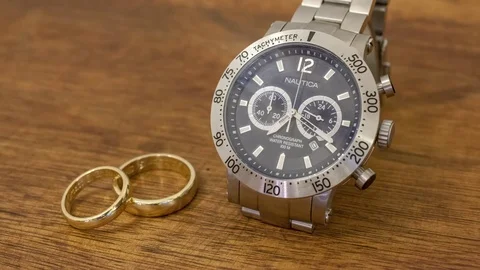 Watch and wedding rings Video stock 83570102