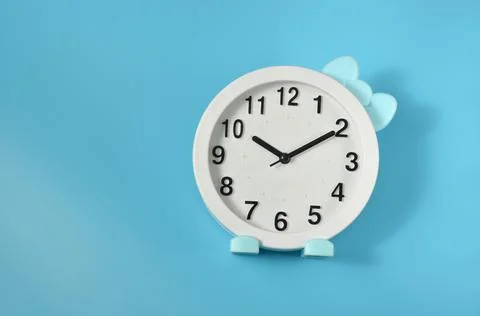 Watch with a bow. Blue background. Stock Photos
