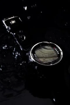 Watch computer for diving in water streams on a black background Stock Photos