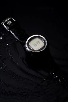 Watch computer for diving in water streams on a black background Stock Photos