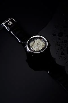 Watch computer for diving in water streams on a black background Stock Photos