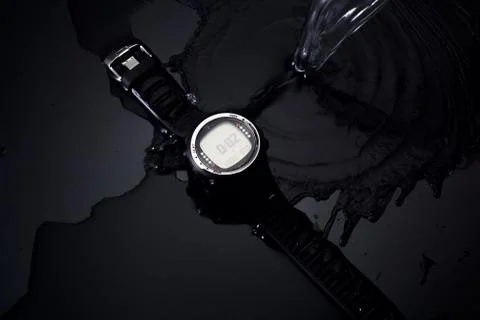 Watch computer for diving in water streams on a black background Stock Photos
