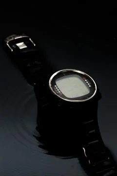 Watch computer for diving in water streams on a black background Stock Photos