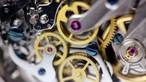 Watch mechanism clockwork with golden cogwheels and jewels running steel Stock Footage 242595136