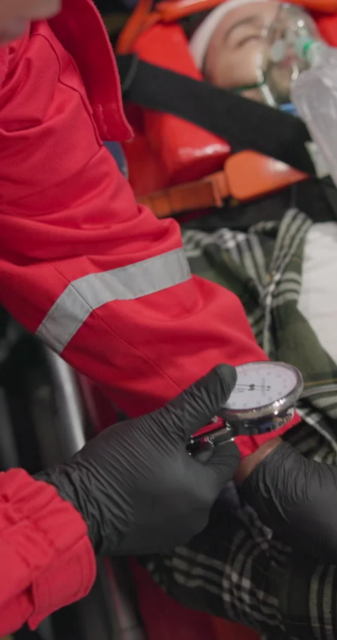 Watch, pulse and hands of an emt with a patient in an ambulance for rescue Stock-Footage 252642592