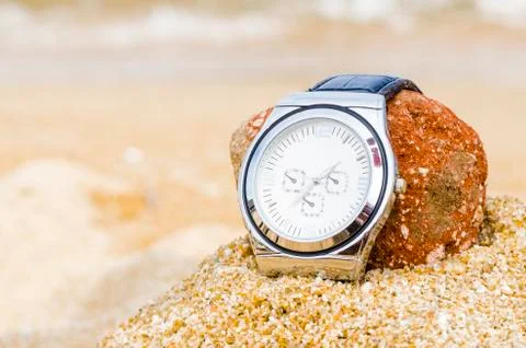 Watch in sand Stock Photos