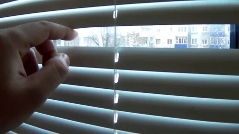 Watch the street through the blinds Stock Footage 70986994
