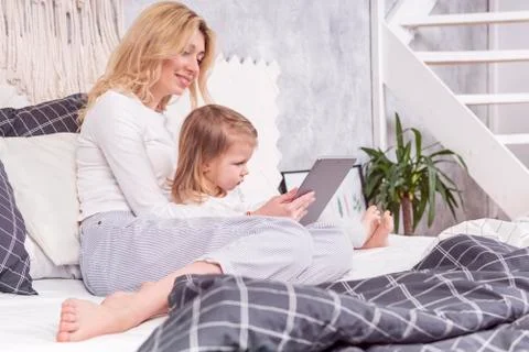 Watch tablet on the bed Stock Photos