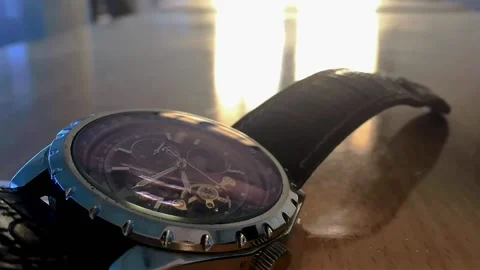 A Watch Timelapse on a Table with black leather strap and a motor watch Stock Footage 162886967