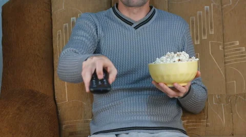 Watch TV with eating popcorn Stock Footage 44930351