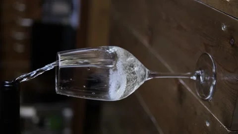 Watch white wine flow elegantly into crystal clear glass capturing the essence Stock Footage 273680071