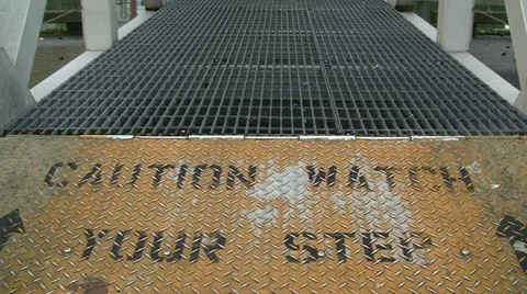 Watch Your Step Grated Walkway Sign Stock Footage 19212864