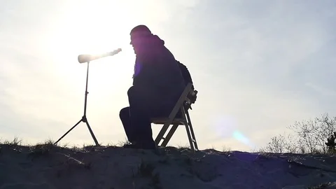 Watcher with monocular outdoors approaching camera silhouette Stock Footage 88918824