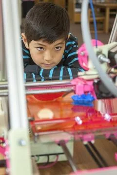 Watching 3D printer intently. Stock Photos
