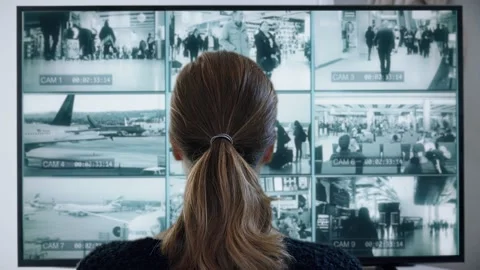 Watching Airport Security Cameras CCTV Multiscreen Monitors Video stock 149763023