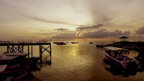 Watching the boats drift gently under the golden sunset Stock Footage 304257933