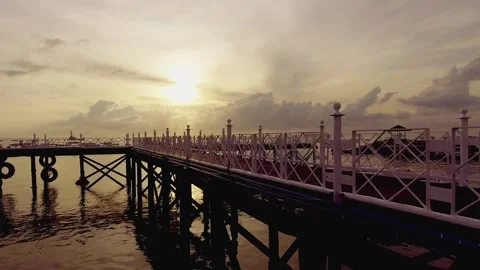 Watching the boats drift gently under the golden sunset Stock Footage 304257991