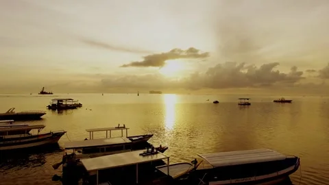 Watching the boats drift gently under the golden sunset Stock Footage 304258052