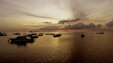 Watching the boats drift gently under the golden sunset Stock Footage 304258093