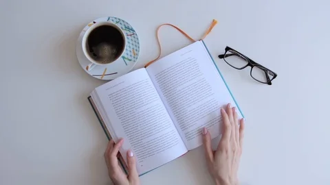 Watching book with Cup of coffee Stock Footage 87951200