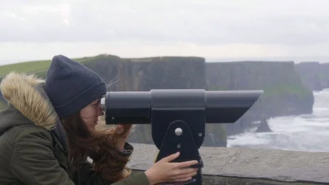 Watching the Cliffs of Moher in Ireland through a spyglass Stock Footage 95559531