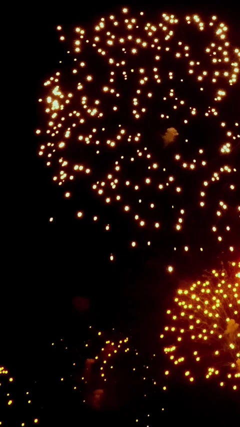 Watching Colorful Fireworks Explode in the Night Sky During Celebration Stock Footage 323376563