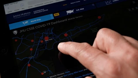 Watching coronavirus stats on internet Stock Footage 128324616