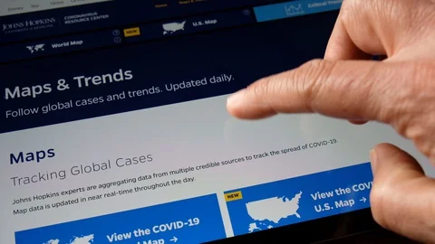 Watching coronavirus stats on internet Stock Footage 128324642
