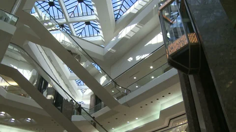 Watching elevator descend from glass ceiling within mall (1 of 2) Stock Footage 32327051