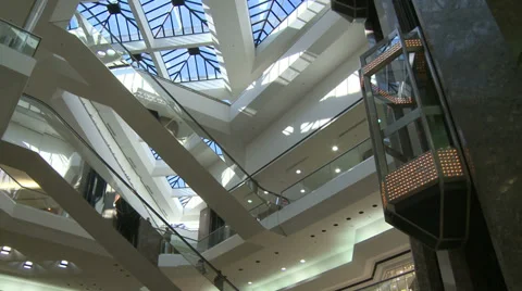 Watching elevator descend from glass ceiling within mall (2 of 2) Stock Footage 32327055