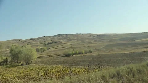 Watching the fields and the sky from the car window. Stock Footage 165370403