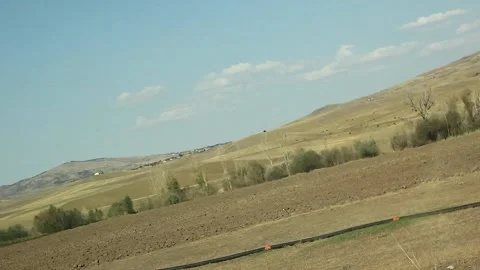 Watching the fields and the sky from the car window. Stock Footage 165370511