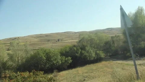 Watching the fields and the sky from the car window. Stock Footage 165371051