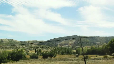 Watching the fields and the sky from the car window. Stock Footage 165371096
