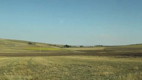 Watching the fields and the sky from the car window. Stock Footage 165372266