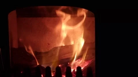 Watching glowing fire in the fire place Video stock 166924446