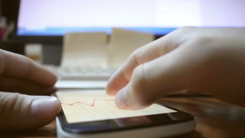 Watching A Graph On Smartphone Stock Footage 234780018