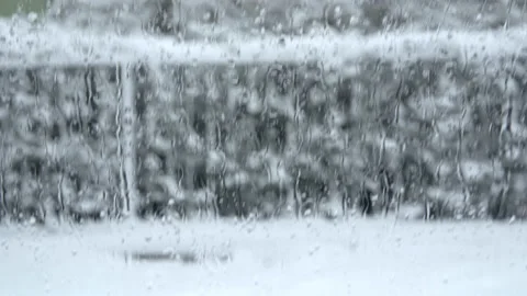 Watching the heavy snow fall through a wet car window Stock Footage 237472318