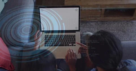 Watching mentor-student duo coding and pointing on gray couch at home with Stock Photos