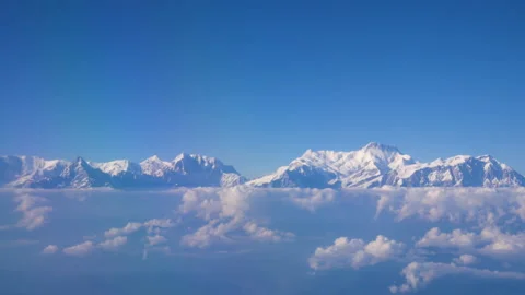 Watching the mountains covered with white snow shining  from 16000ft high. Stock Footage 281242804