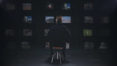 Watching Multiscreen Television Monitors, Man Sitting Watching TV Stock Footage 161807248
