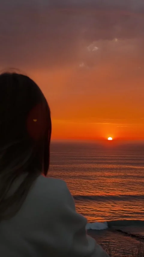 Watching Orange Sunset Over Ocean from Woman’s Shoulder. Stock Footage 328045295
