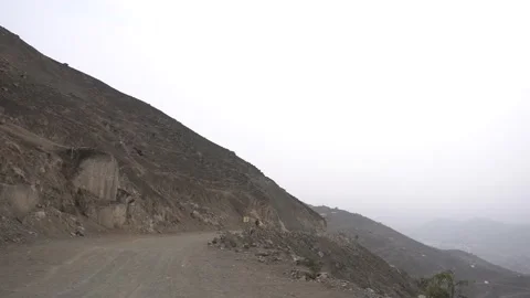 Watching over the edge of a mountain while hiking Stock Footage 145110950