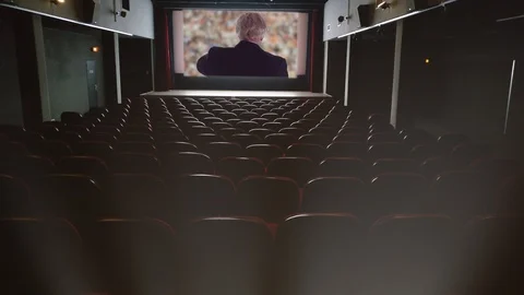 Watching President Donald Trump on big screen in empty theater Stock Footage 105963988