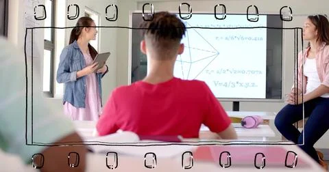 Watching seated student in red tee facing front in classroom, presenter holding Stock Photos