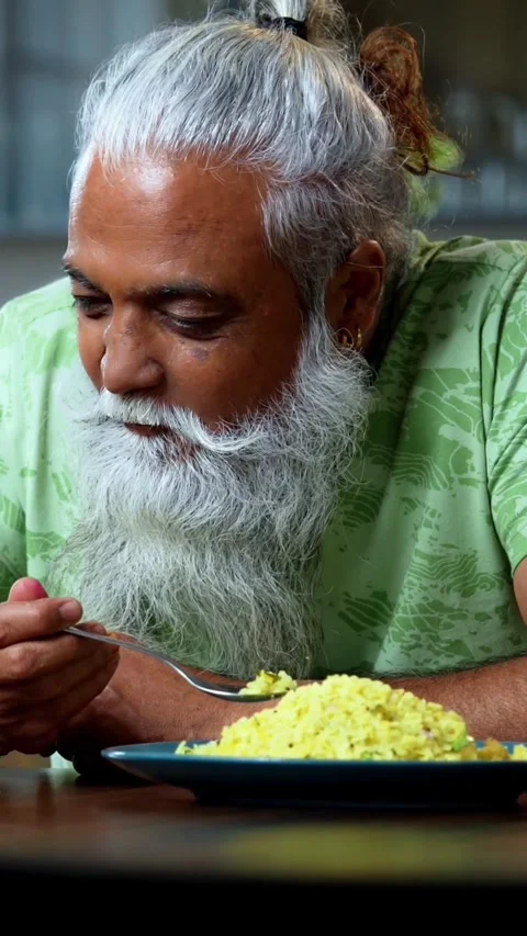 Watching smartphone reels while eating, Indian mid age man at breakfast 스톡 동영상 342756883