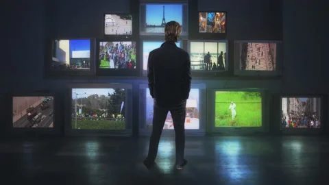 Watching Stack of Television Monitors Back of Man Standing In Front of TVs Stock Footage 161953389