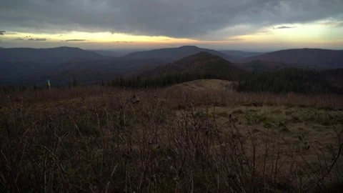 Watching the sunset from a mountain overlook in the evening with trees Video stock 337638013